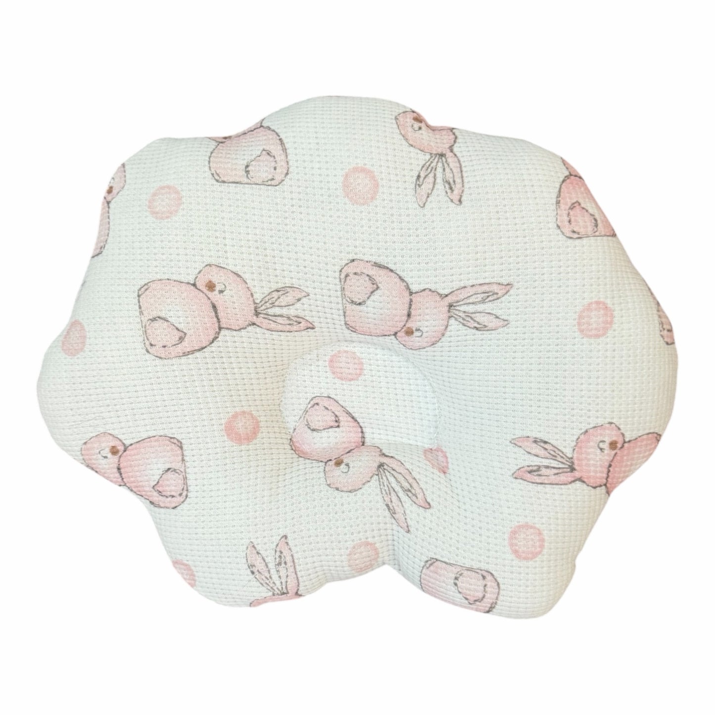 Almohada ortopédica Acüchichi para bebé con forma de flor, tela transpirable tipo panal y estampado de conejitos rosas.