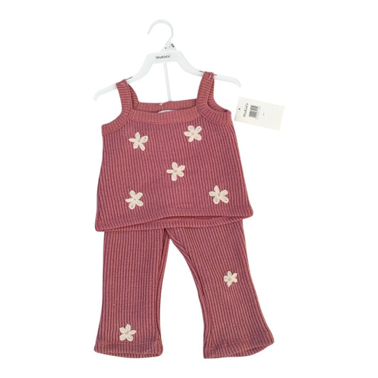Conjunto Acüchichi de dos piezas para niña en tejido acanalado rosa con flores aplicadas en relieve