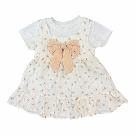 Vestido casual Acüchichi para niña con estampado floral, lazo decorativo color neutro y detalle de volantes en el ruedo.